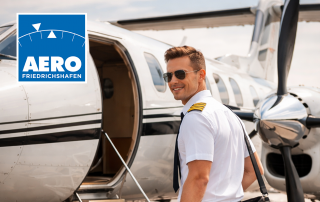 Pilot in Uniform mit Schulterstreifen beim Einsteigen in ein privates Turboprop-Flugzeug auf dem Vorfeld eines Flughafens